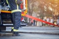 Firefighter in protective uniform. Fireman standing near a fire truck. Fire truck with equipment Royalty Free Stock Photo