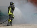 Firefighter with protective uniform and helmet turn off the fire