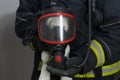 A firefighter put a breathing mask on a child`s toy, a rescued teddy bear Royalty Free Stock Photo