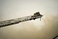 A firefighter puts out a burning building with height extension ladders