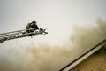 A firefighter puts out a burning building with height extension ladders