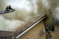 A firefighter puts out a burning building with height extension ladders