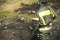 Firefighter puts out fire. Lifeguard pours water from hose Royalty Free Stock Photo