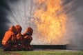 Firefighter Rescue training in fire fighting extinguisher. Firefighter fighting with flame using fire hose chemical water foam