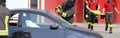 firefighter with special glass cutting hacksaw while removing the windshield to free the injured person