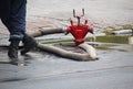 Firefighter stands near a hose connected to a hydrant