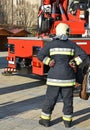 Firefighter stands next to a crane