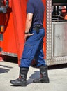 Firefighter stands next to a firetruck