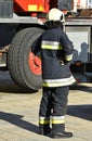 Firefighter stands next to a vehicle