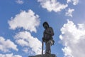 Firefighter statue with sky and clouds in the background