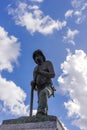 Firefighter statue with sky and clouds in the background