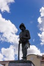 Firefighter statue with sky and clouds in the background