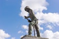 Firefighter statue with sky and clouds in the background