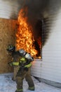 Firefighter tackling blaze Royalty Free Stock Photo