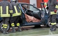 Firefighter team extracts the person from inside the car after a