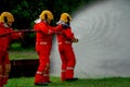 Firefighter team help to use fire sprinkler to generate water curtain and protect them from fire also use to get rid of fire Royalty Free Stock Photo