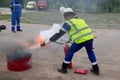 Firefighter on training. Fireman using use a fire extinguisher on a training fire