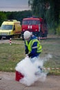 Firefighter on training. Fireman using use a fire extinguisher on a training fire