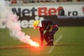 Firefighter tries to extinguish torches thrown on the grass