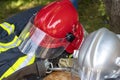 Firefighter uniform with red helmet. Close-up image of a red helmet of a fireman.