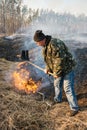 Firefighter use leafs branch for forest fire suppression