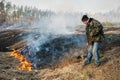 Firefighter use leafs branch for forest fire suppression