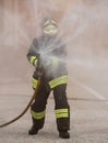 Firefighter uses a fire extinguisher to extinguish a fire Royalty Free Stock Photo