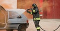 Firefighter uses foam on the car Royalty Free Stock Photo