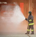 Firefighter uses a foam to extinguish a fire Royalty Free Stock Photo