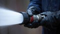 Firefighter using a hose to spray water during emergency response Royalty Free Stock Photo