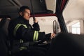 Firefighter using radio while driving fire truck Royalty Free Stock Photo