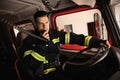 Firefighter using radio set while driving fire truck Royalty Free Stock Photo