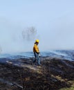 Firefighter walking through the smoldering ground Royalty Free Stock Photo