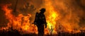 Firefighter walks past burning forest as he battles wildfire Royalty Free Stock Photo