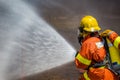 Firefighter water spray by high pressure fire hose