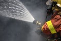 Firefighter water spray by high pressure fire hose surround with