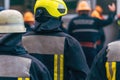 Firefighters in action, rear view of firemen in protective clothing Royalty Free Stock Photo