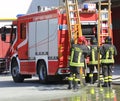 Firefighters in action take the wooden ladder Royalty Free Stock Photo