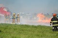 Firefighters applying foam