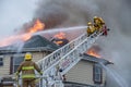 Firefighters battle blazing house fire Royalty Free Stock Photo