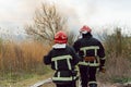 Firefighters battle a wildfire. firefighters spray water to wildfire. Australia bushfires, The fire is fueled by wind and heat Royalty Free Stock Photo