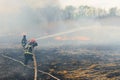 Firefighters battle a wildfire. firefighters spray water to wildfire. Australia bushfires, The fire is fueled by wind and heat Royalty Free Stock Photo