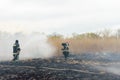 Firefighters battle a wildfire. firefighters spray water to wildfire. Australia bushfires, The fire is fueled by wind and heat Royalty Free Stock Photo