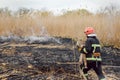 Firefighters battle a wildfire. firefighters spray water to wildfire. Australia bushfires, The fire is fueled by wind and heat Royalty Free Stock Photo