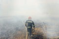 Firefighters battle a wildfire. firefighters spray water to wildfire. Australia bushfires, The fire is fueled by wind and heat Royalty Free Stock Photo