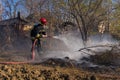 Firefighters battle a wildfire in a forest.