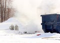 Firefighters battling dumpster fire on a cold winter day