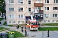 Firefighters at beginning of action stand with two police officers next to the fire truck