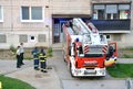 Firefighters at beginning of action stand with two police officers next to the fire truck