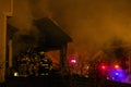 Firefighters Breaking Into a Burning House